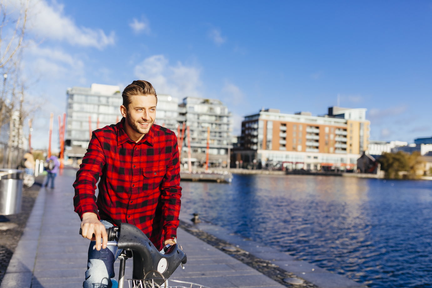 Ireland, Dublin, young man go to work at city dock with city bike
